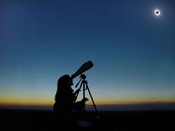 Girl viewing Solar Eclipse using Astronomy Binocular